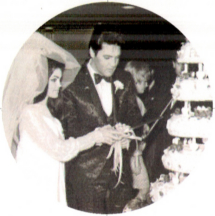 Elvis and Priscilla Presley cut the wedding cake