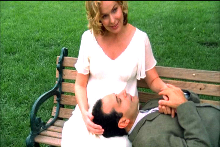 Trudy holding Adrian Monk on a park bench