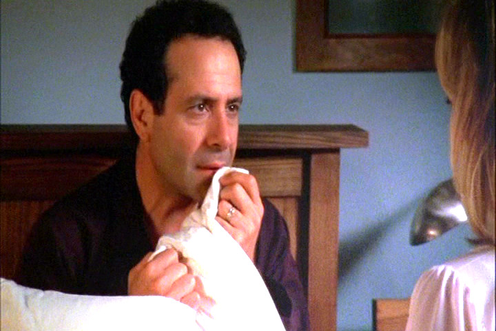 Adrian Monk sniffing Trudy's picture to conjure her up