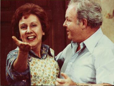 Edith and Archie Bunker smiling
