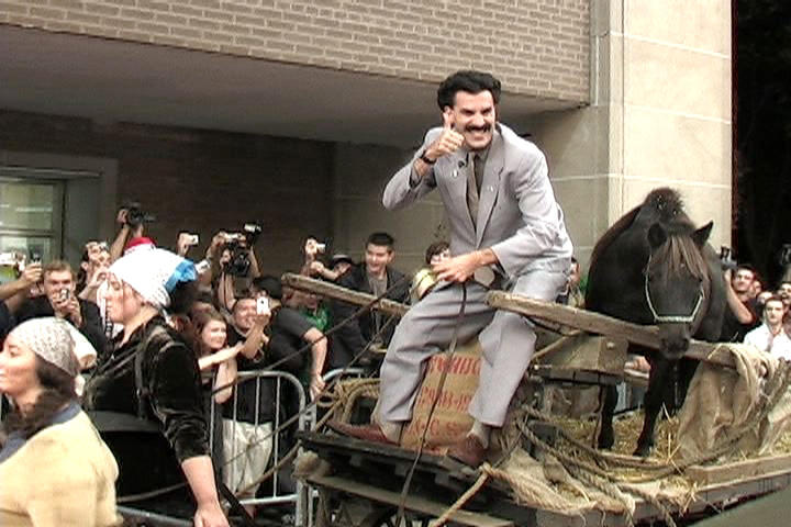 Borat and his horse in an oxcart pulled by peasant women