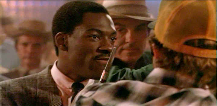 Reggie Hammond wielding a switchblade knife