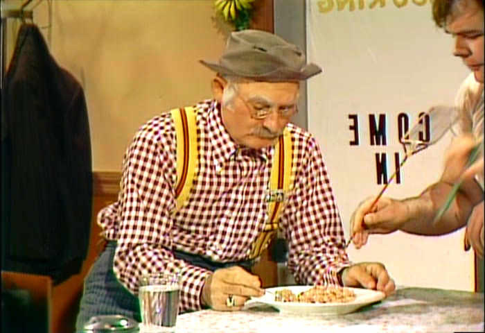 Gailard Sartain uses his fly swatter to pick the bugs out of Grandpa Jones dinner