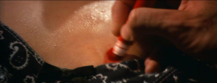 drawing a target on Mia Wallace's chest