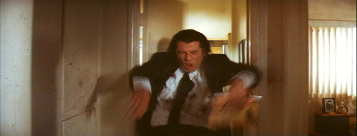Vincent Vega (John Travolta) getting shot in Pulp Fiction