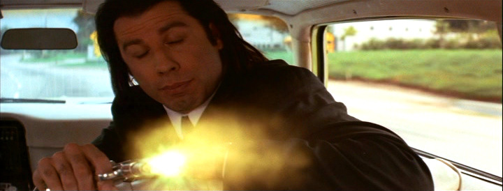 John Travolta as Vincent Vega shooting Marvin in the face