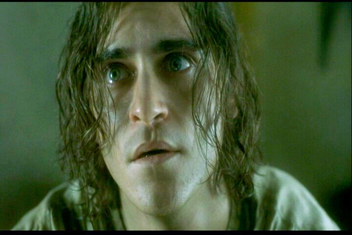crazy long haired Joaquin Phoenix