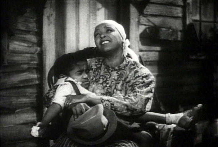 Sammy Davis sitting on Ethel Waters' lap