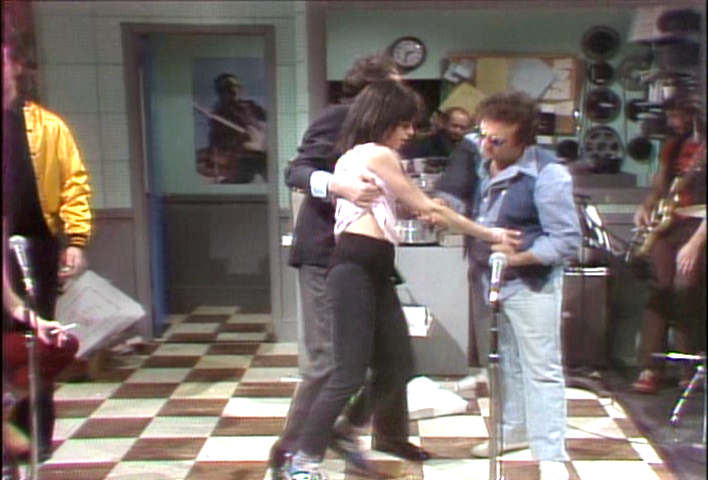 John Belushi checking out Gilda Radner's needle marks