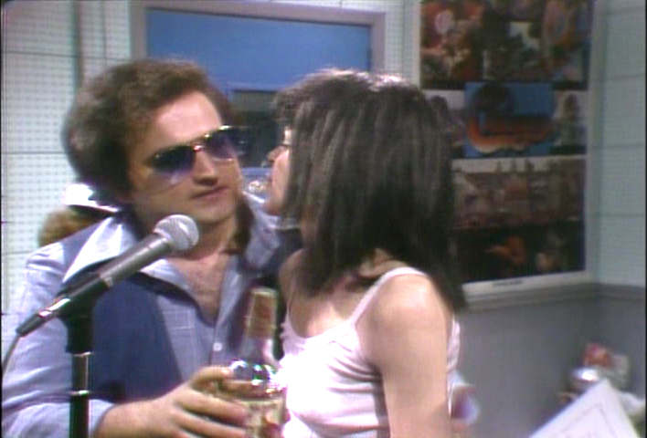 Gilda Radner spits whiskey in John Belushi's face - 1978 Saturday Night Live image