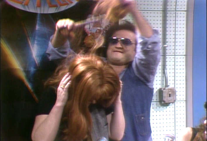 John Belushi cuts Jane Curtin's hair