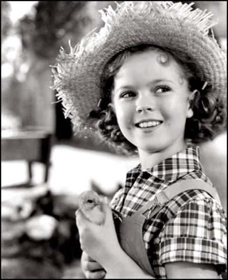 farm girl Shirley Temple with a straw hat and baby chick