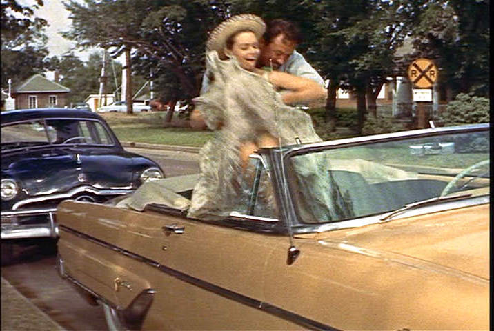 Susan Strasberg lifted into the car