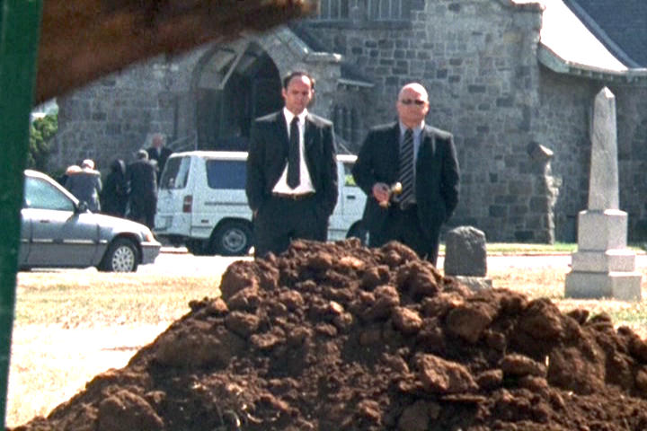 Shane Vendrell and Vic Mackey watch the machine dig their buddy's grave