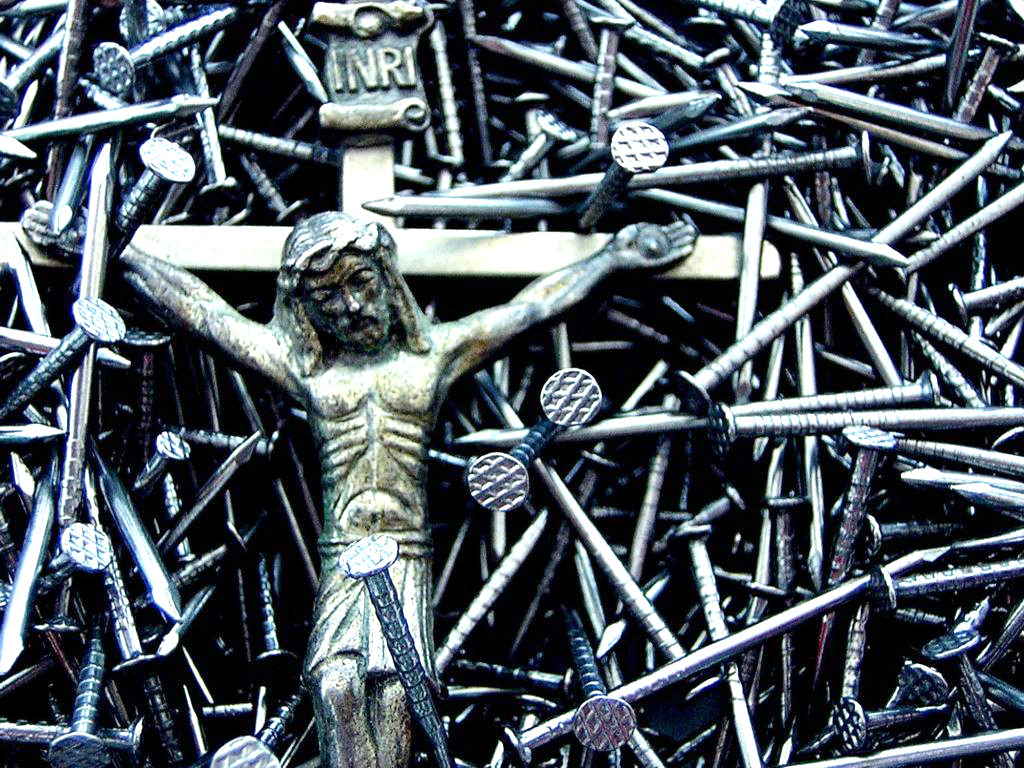 sculpture of Jesus Christ on the cross, with hundreds of nails