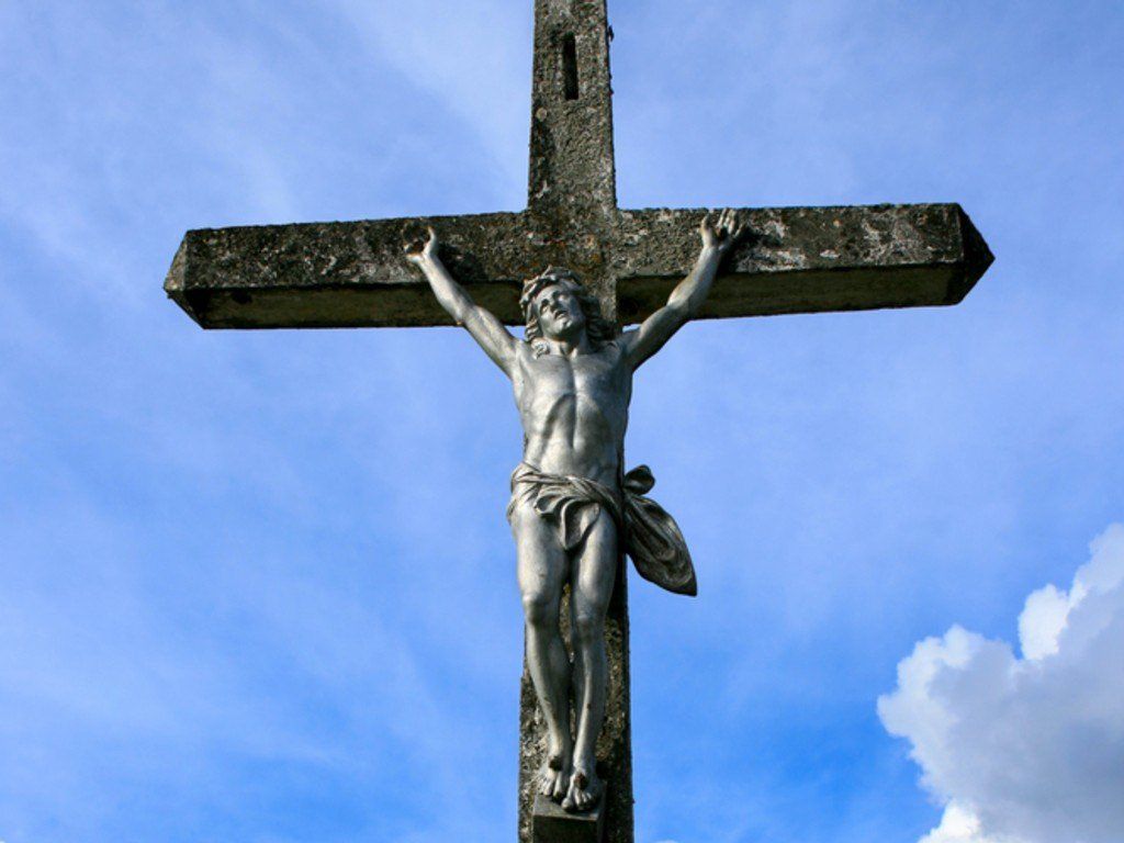 iron sculpture of Christ on the cross