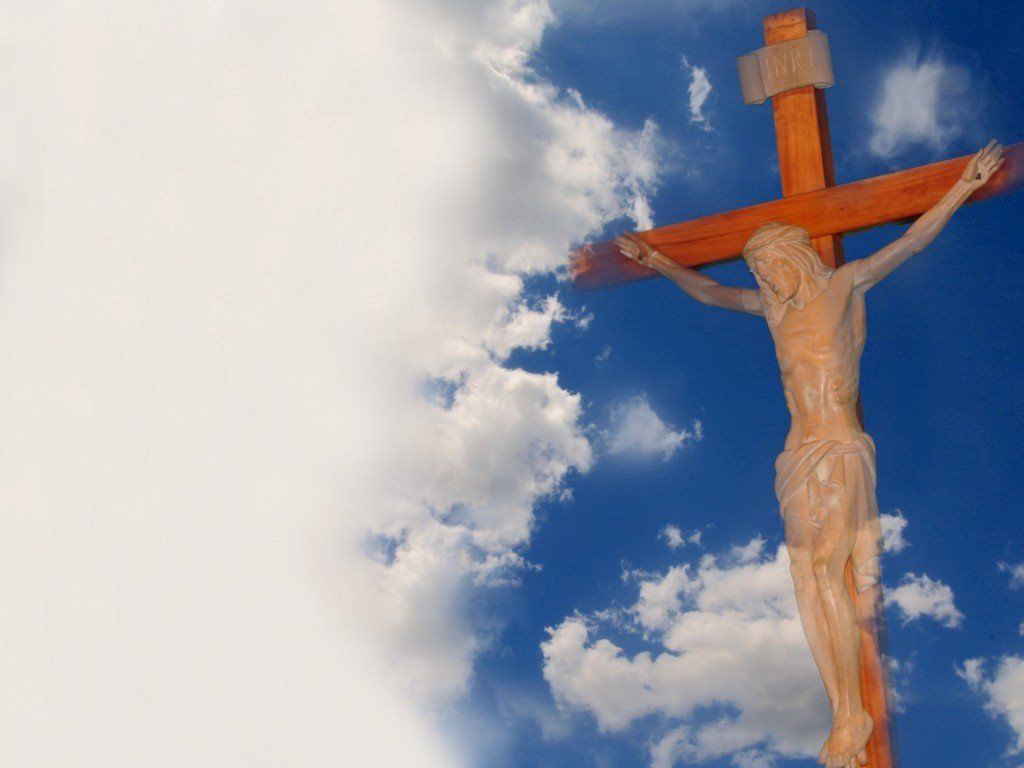 sculpture of Jesus on the cross amongst the clouds