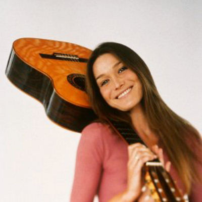 young Carla Bruni with guitar