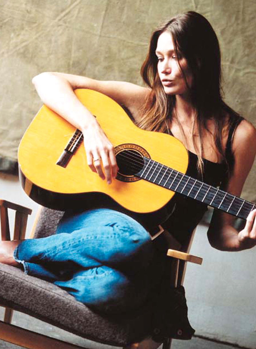 Carla Bruni playing guitar