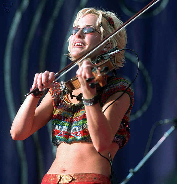 Dixie Chick playing fiddle on stage with a bare midriff