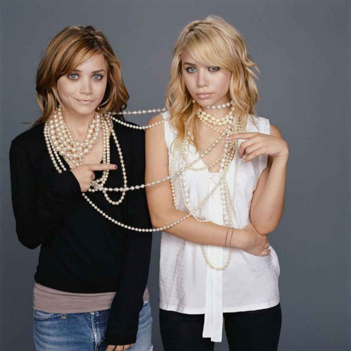 Mary-Kate and Ashley Olsen are tied up in a pearl necklace