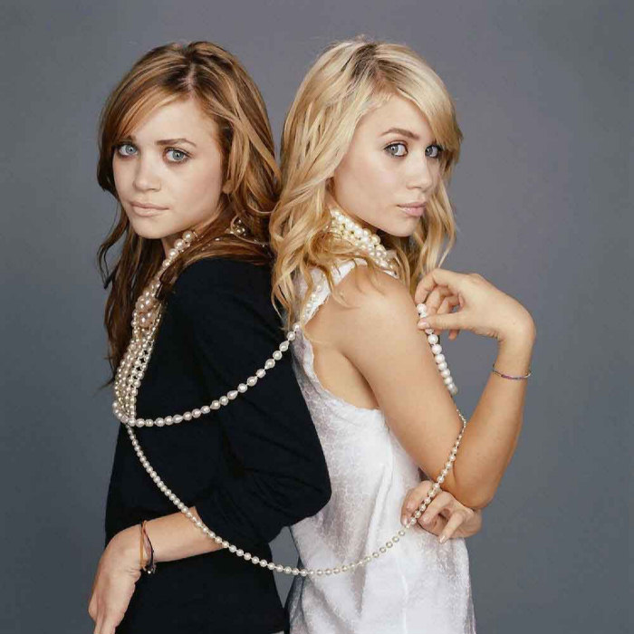 the Olsen twins are tied together with a pearl necklace