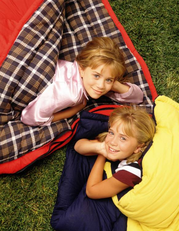 childhood photo of the Olsen twins in sleeping bags