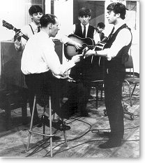 George Martin instructing the young Beatles in the studio