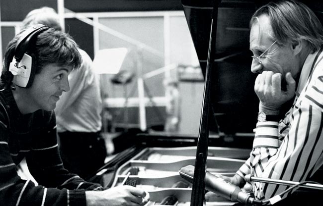 Paul McCartney smiling at George Martin