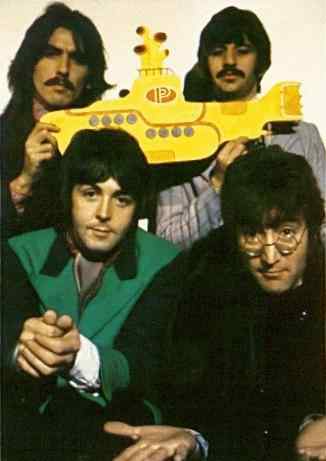 the Beatles holding a cutout of the Yellow Submarine