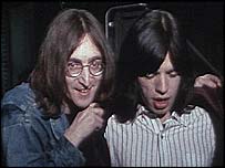 John Lennon and Mick Jagger eye a cute goat