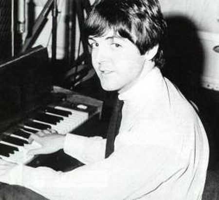 young Paul McCartney playing piano