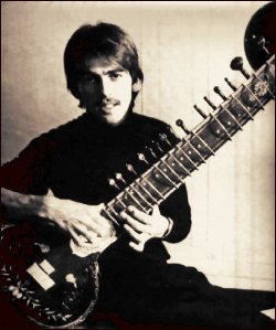 George Harrison holding sitar