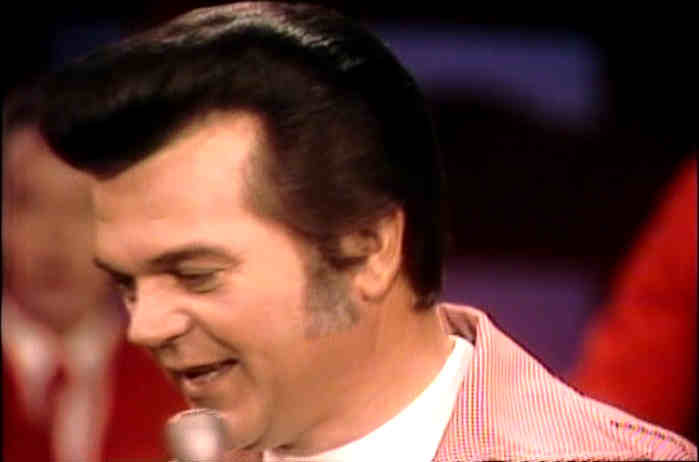 Conway Twitty singing on stage