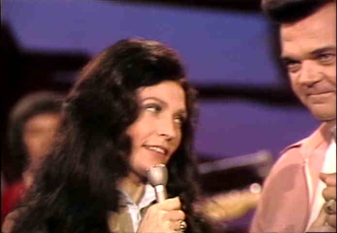 Loretta Lynn looking at Conway Twitty, 1974 image