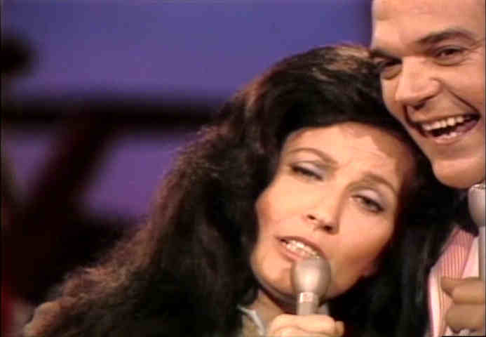 Loretta Lynn leaning on Conway Twitty