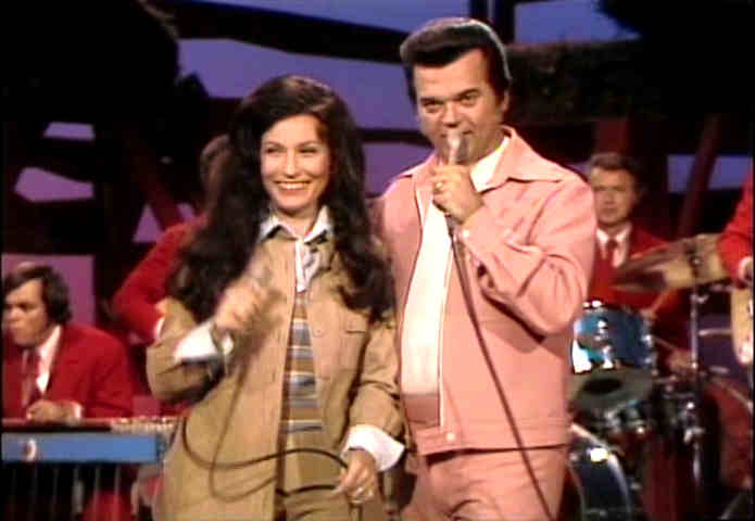 Loretta Lynn performing on stage with Conway Twitty