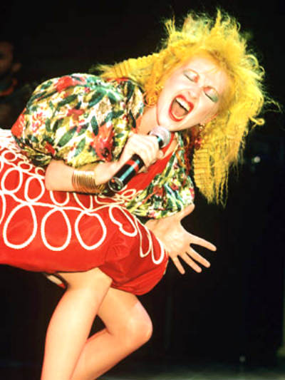Cyndi Lauper on stage in her full multi-hued glory