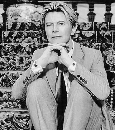 black and white photo of David Bowie in a suit and tie