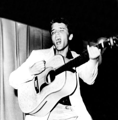 young Elvis Presley playing guitar