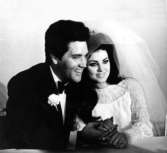 Elvis and Priscilla Presley in her wedding gown