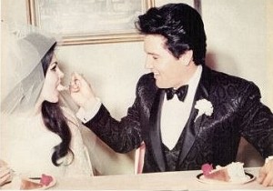 Elvis Presley feeding his bride wedding cake