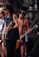 shirtless Slash on stage