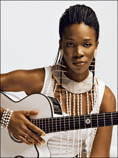 the white clothes and guitar perfectly set off India.Arie's beautiful brown skin