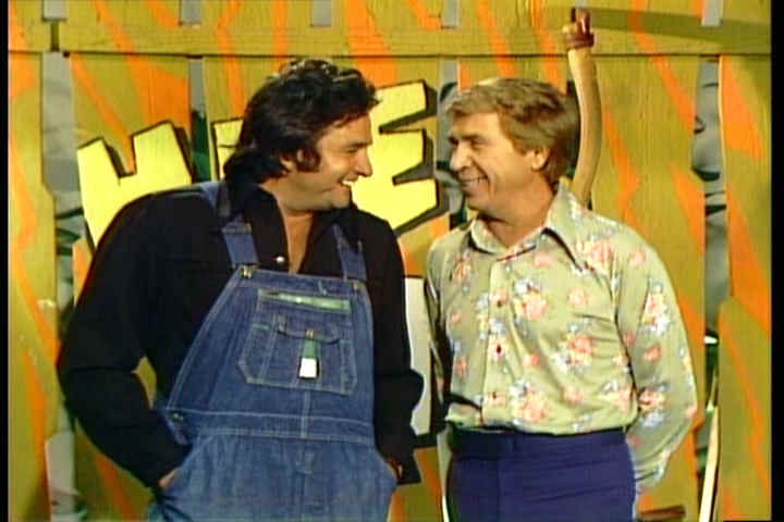 Johnny Cash in overalls with Buck Owens in a particularly ugly 1970s shirt