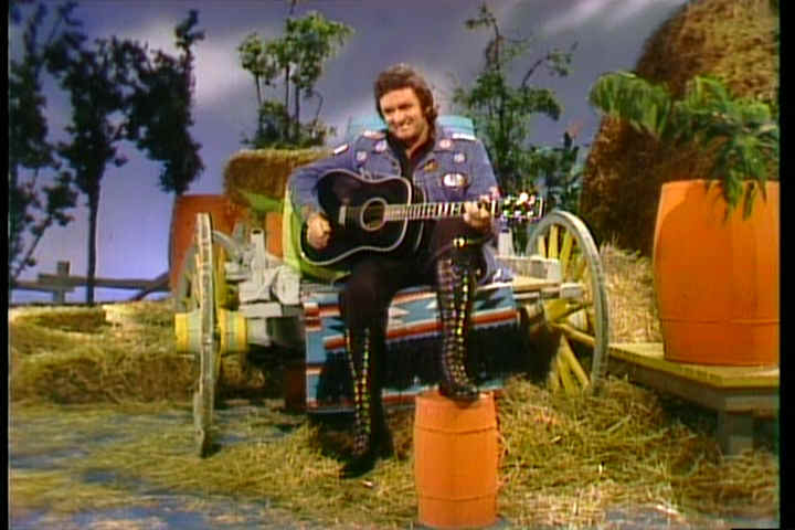 Johnny Cash on a particularly fake looking "country" set