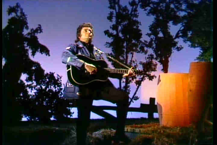 Johnny Cash on a particularly fake looking "country" set