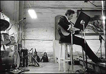 black and white photo of Johnny Cash playing guitar