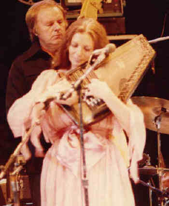 June Carter playing autoharp onstage
