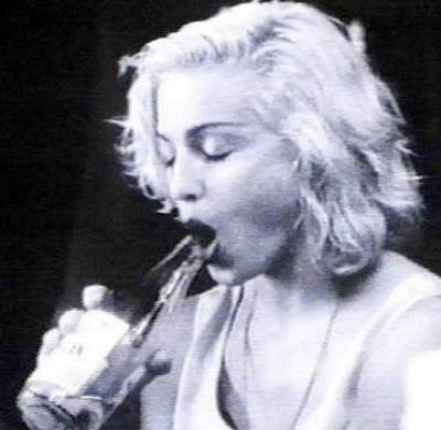 Madonna Louise Ciccone illustrates her fellatio technique on a wine bottle